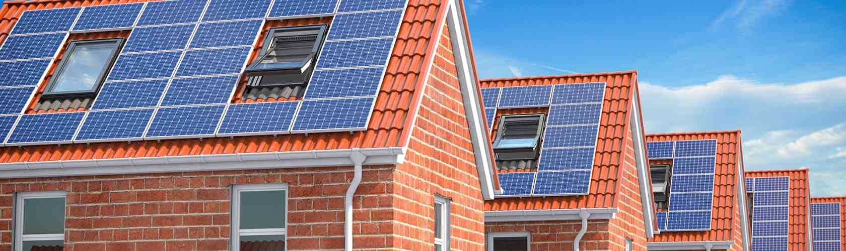 Row of house with solar panels on roof on blue sky AZR29 CK